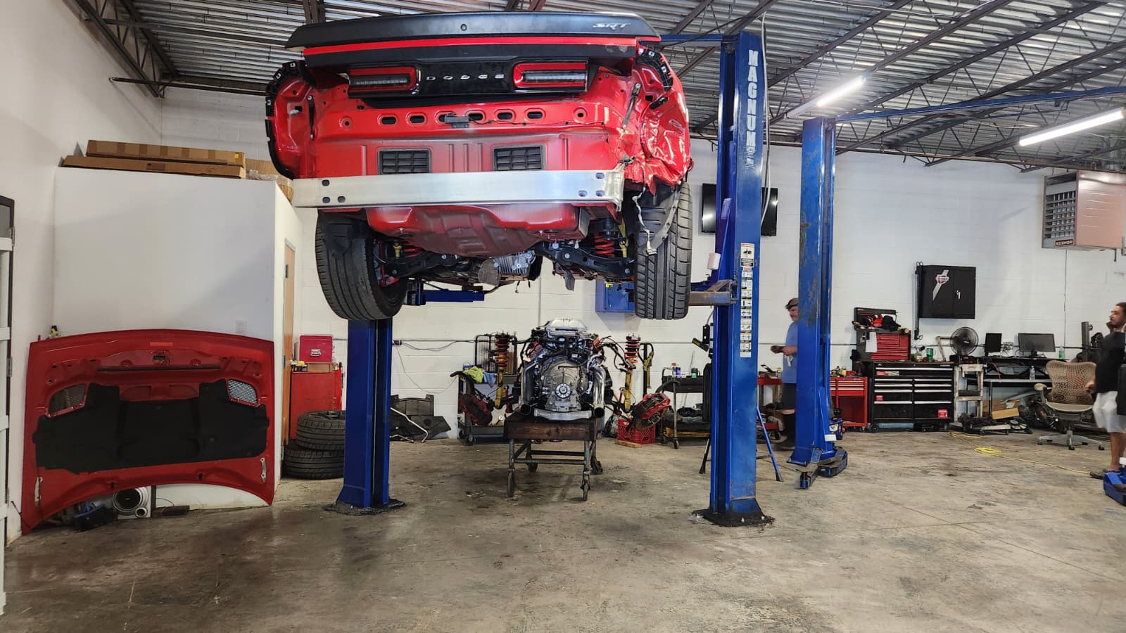 Collision repair — vehicle lifted for body work