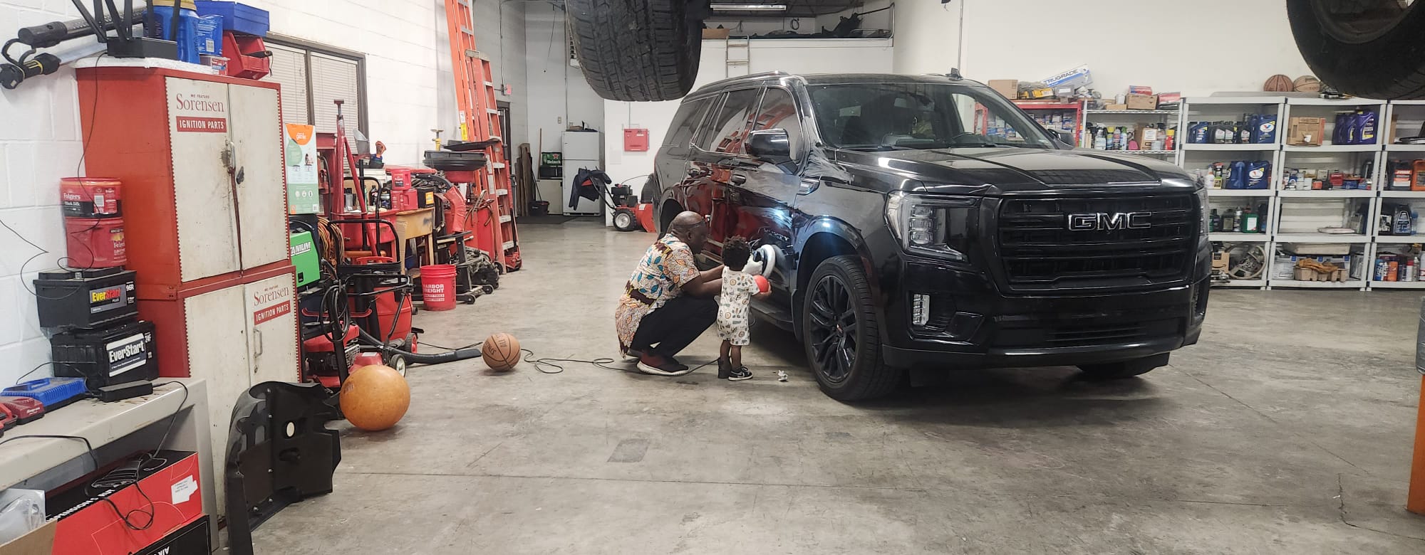 Wide view of the shop with GMC Yukon being serviced